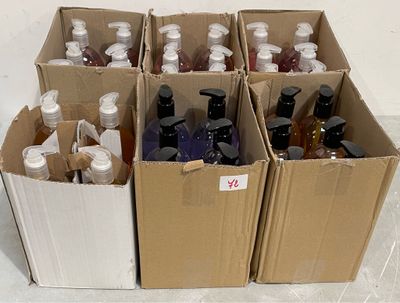 many bottles of alcohol in a cardboard box on the floor
