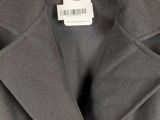 a close up of a coat on a hanger on a white background