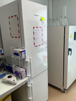 two refrigerators that are sitting next to each other in a room