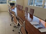 tables and chairs in a conference room with a view of the city