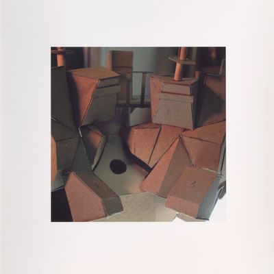 a cat that is sitting in a pile of boxes