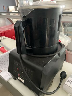 a black blender sitting on a counter in a kitchen