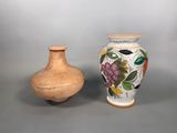 two vases sitting next to each other on a table
