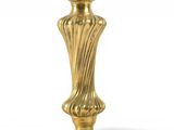 a gold vase that is sitting on a white surface