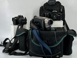 three cameras and a camera bag on a white background
