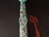 an image of a blue and white vase with a red tassel