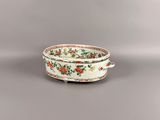 an image of a white bowl with red and green flowers on it