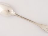 silver spoon on a white surface with a small spoon in the middle of it