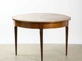 an oval dining table with a wooden top and two legs