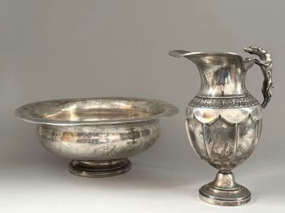 a silver vase and a silver bowl on a table