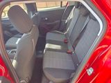 the back seats of a red car are empty and ready to be used