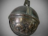 an old bronze bell with a dragon on it sitting on a table