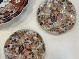 several plates and bowls are sitting on a table with a white table cloth