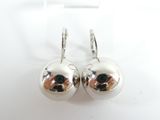 paire de boucles d'oreilles en argent en forme de boules, posées sur une surface blanche, sur fond blanc