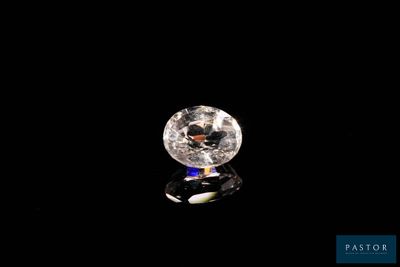 a close up of a white diamond on a black surface