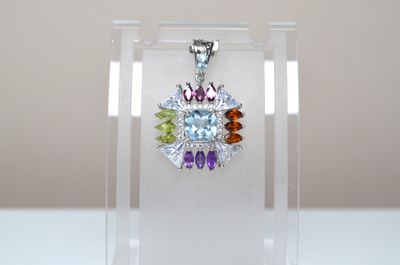 a close up of a necklace on a clear display case