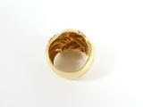 a close up of a gold ring on a white surface
