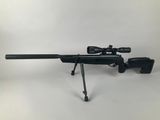 a rifle with a scope on a tripod on a white background