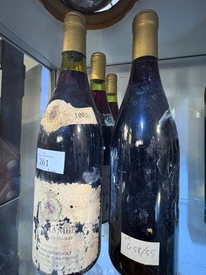 two bottles of wine on display in a glass case