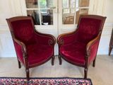 two red chairs sitting next to each other in a room