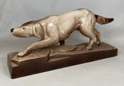 statue of a dog running on a wooden base on a white background