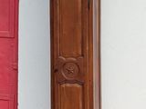 a tall wooden grandfather clock sitting on the sidewalk