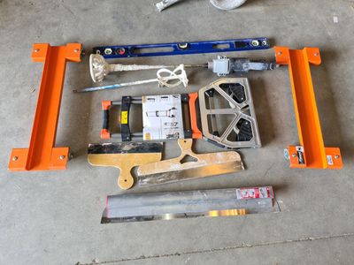 tools laid out on the floor in a garage for repair
