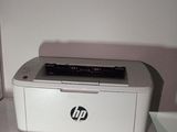 a white printer sitting on top of a white shelf