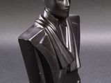 a close up of a busturine of a man wearing a suit and tie