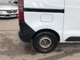 a white van parked in a parking lot with other cars