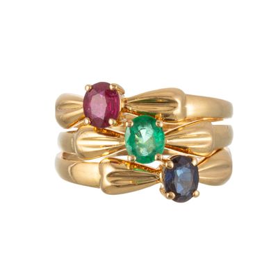 an image of a gold ring with three different colored stones