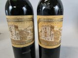 two bottles of wine sitting next to each other on a table