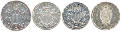four oval metal plaques with ornate designs on them on a white background