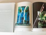 two books are open on a white table with a white table cloth