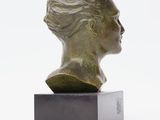 an image of a bronze bust of a woman on a marble base