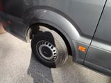a van that has a flat tire on the side of the road