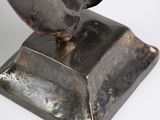 sculpture of a man ' s head on a metal base with a white background