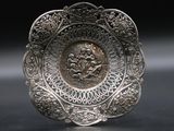 silver plate with a picture of a man and a woman on it