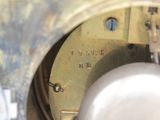 a close up view of a clock with a metal case