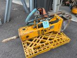 a small yellow machine that is sitting on a pallet