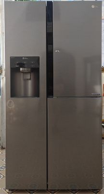 two refrigerators that are sitting in a kitchen