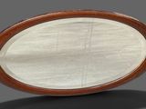 a large oval mirror sitting on top of a table
