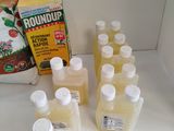 many bottles of liquid sitting on a counter