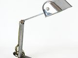 a metal lamp that is sitting on a marble base