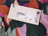 a close up of a colorful shirt with a tag on it