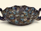 a blue and white bowl with flowers on it