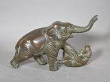 a statue of an elephant and a baby elephant on a table