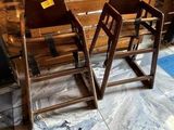 two wooden chairs sitting next to each other on the floor