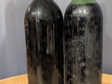 two bottles of wine that are sitting on a table