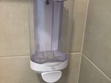 a hand dryer on the wall in the bathroom
